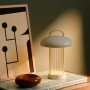 Nordlux Mirano portable bordlampe beige. Miljøbilledet viser produktet i stue.