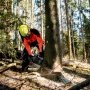 En professionel bruger en Metabo akkukædesav til at udføre præcise snit i træ.